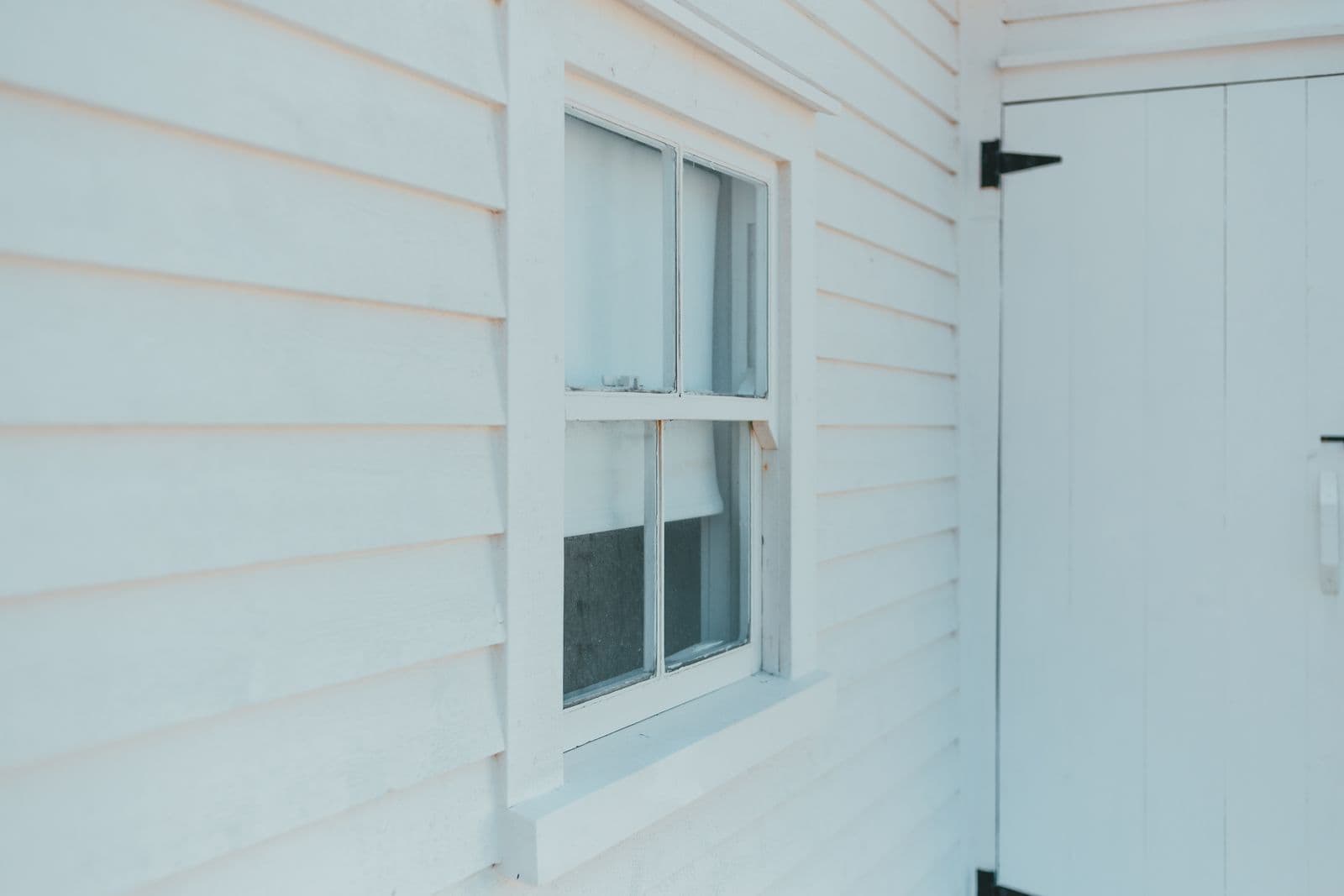 White lap siding beside a window and door